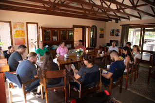 Group of people around a table studying and discussing the explanations of the human condition