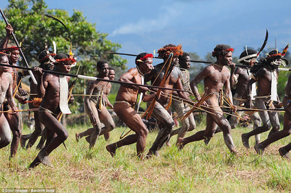 A tribe of New Guineans charging into battle A tribe of New Guineans charging into battle
